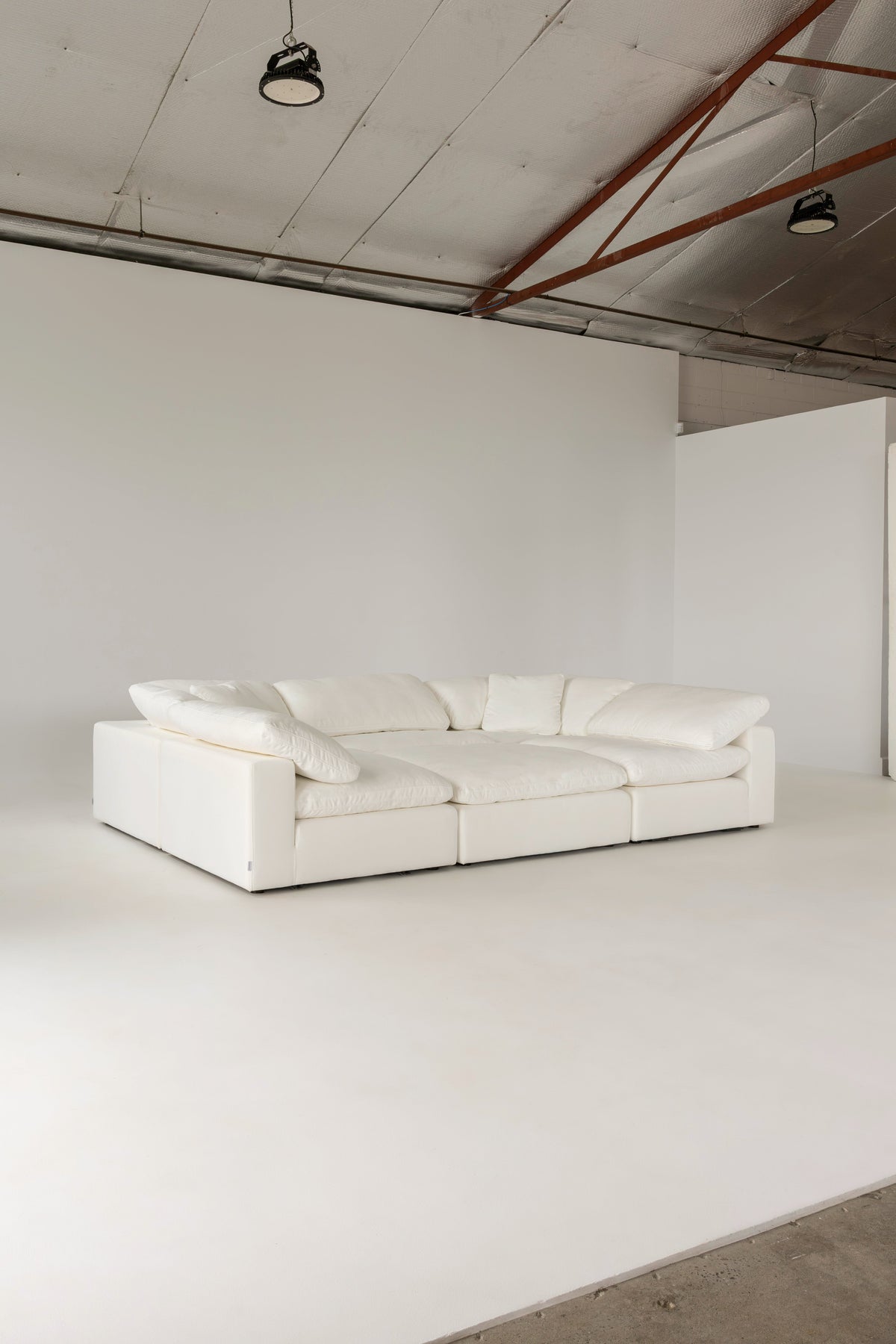 Cloud Classic pit sectional arranged as a daybed in a studio space